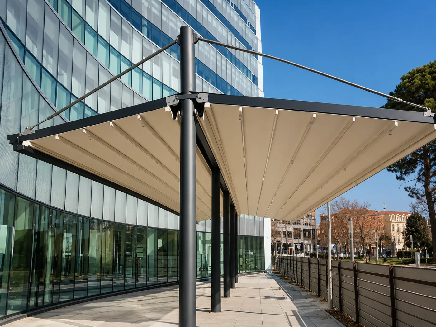 Free-standing pergola awning in front of the curved glass facade of an office building